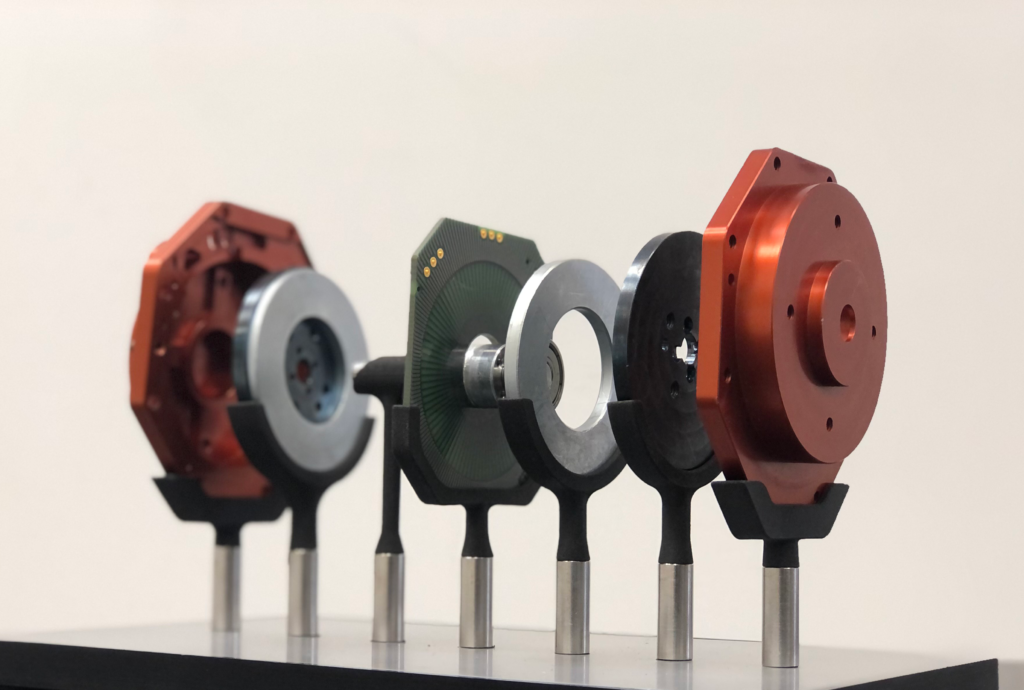 Image of a PCB Stator Electric motor exploded to show componants
